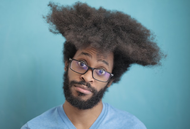 homme portant des lunettes regarde avec étonnement devant lui